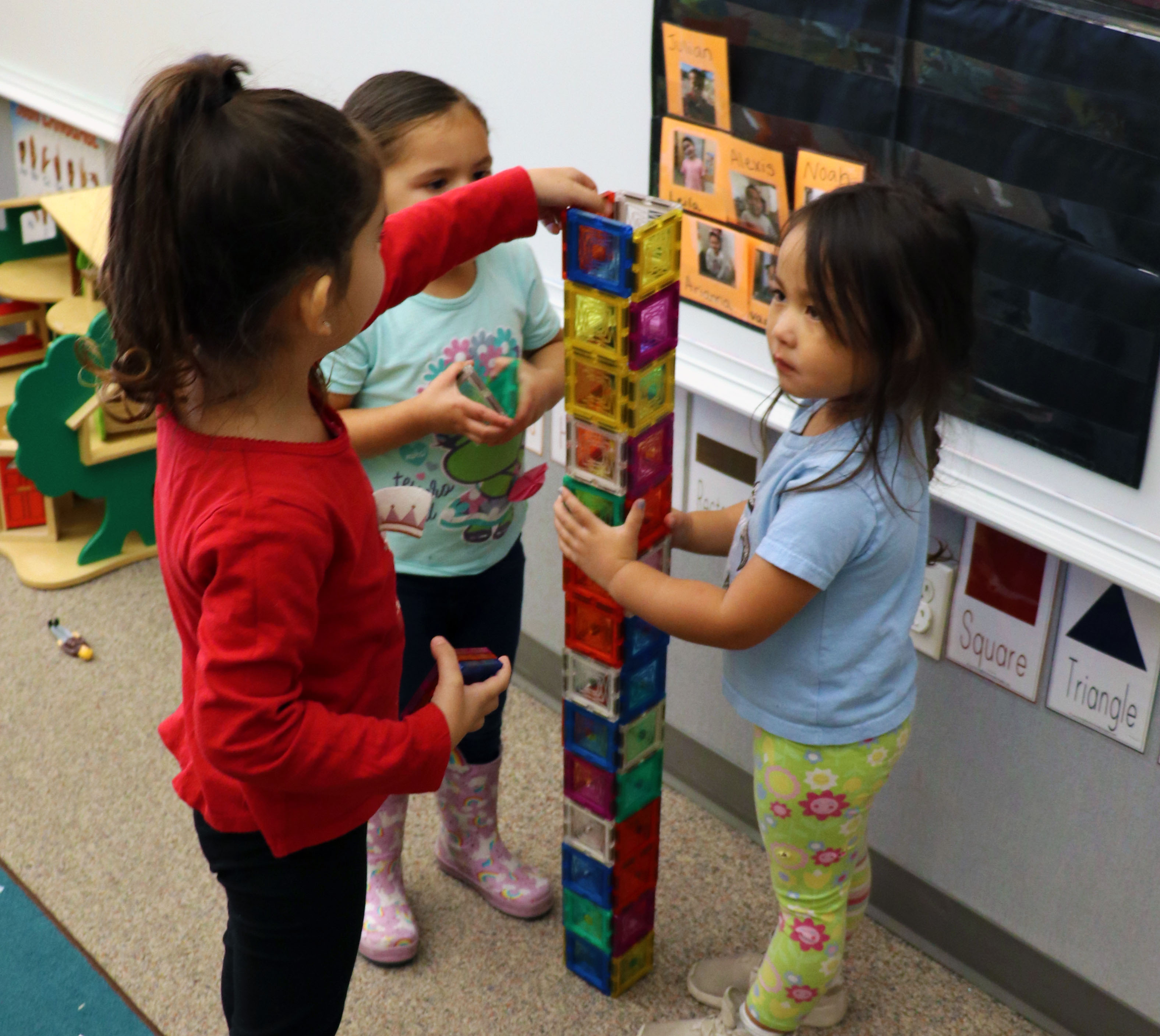 Girls building magnetic tower