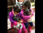 Girls hugging their baby dolls