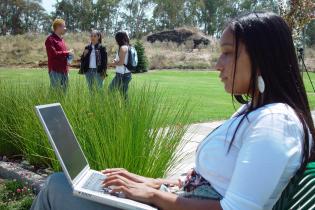Student on laptop outside