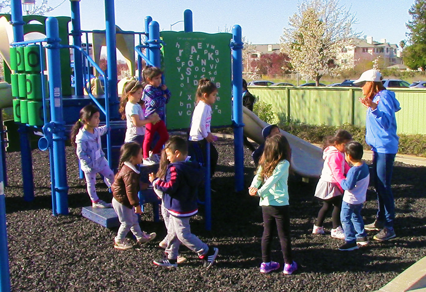Group of preschoolers at the park with their teacher
