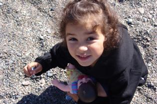 Little girl is holding rocks